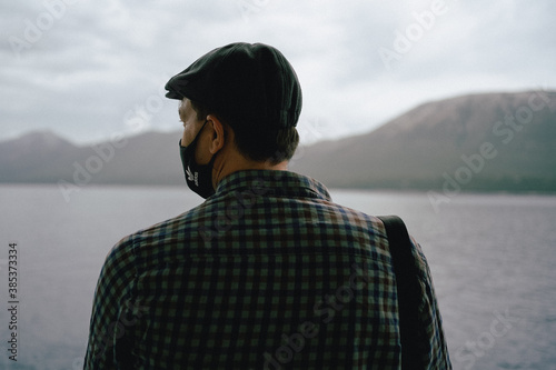 Man with face mask on ferry.