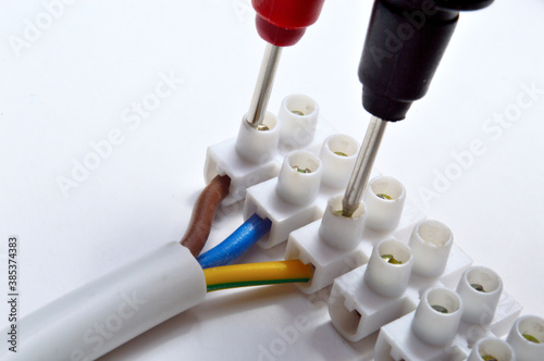 electrical tester terminal block and nippers. on a light background.Close-up..