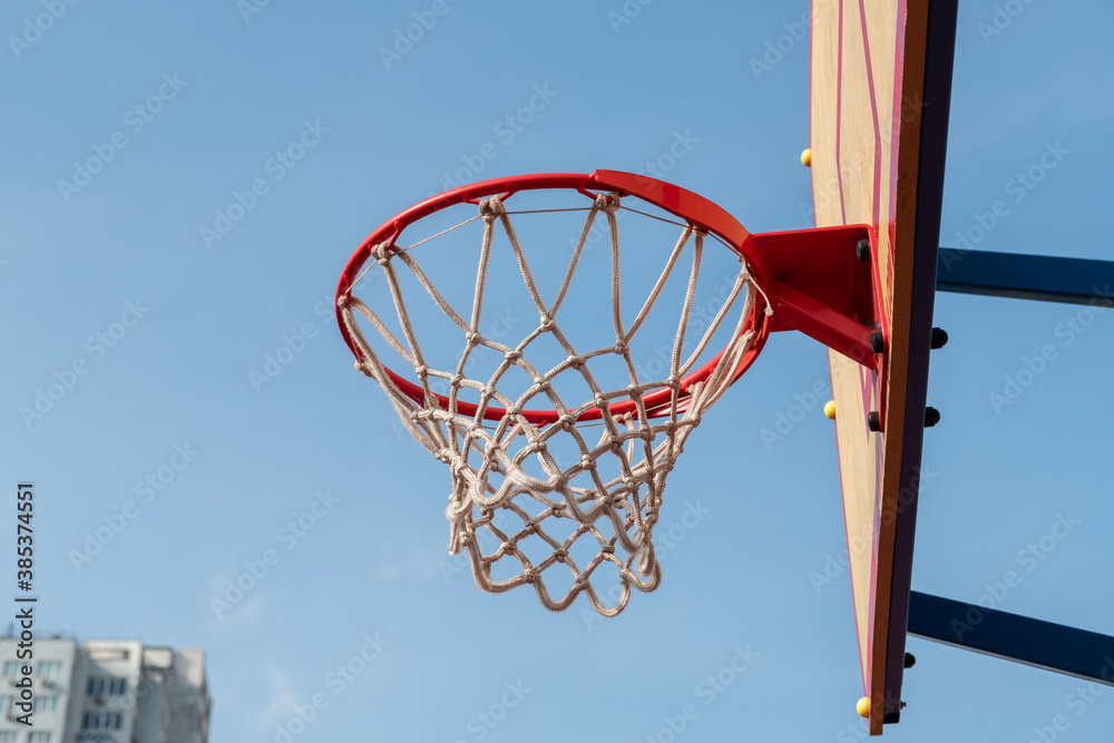 Nice red basketball rim and board on blue sky background sport health