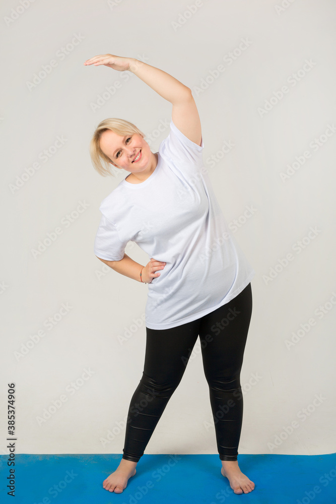 beautiful young plump female in a white t-shirt goes in for sports on a white background beautiful young plump female in a white t-shirt goes in for sports on a white background