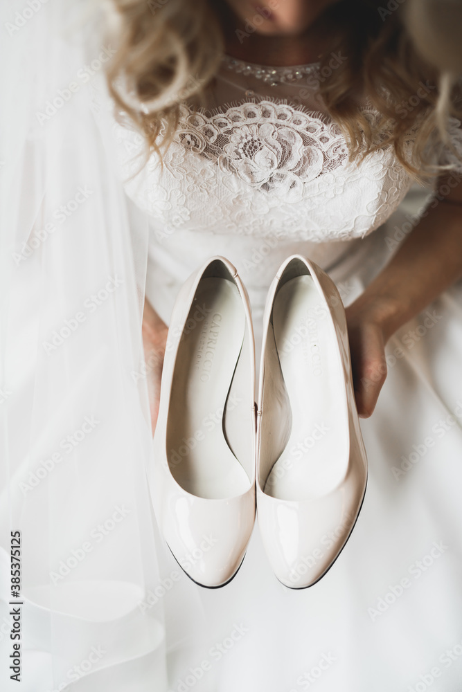 White stylish wedding shoes for bride. Close-up White stylish wedding shoes for bride. Close-up