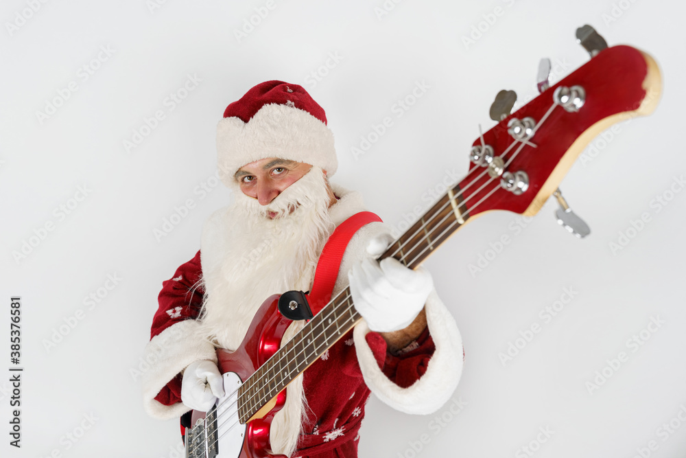Santa Claus plays the guitar. Isolated on white Santa Claus plays the guitar. Isolated on white