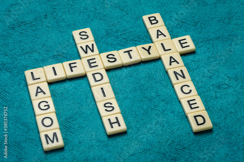 Fotografija lagom crossword in ivory letters against textured paper, Swedish moderation and