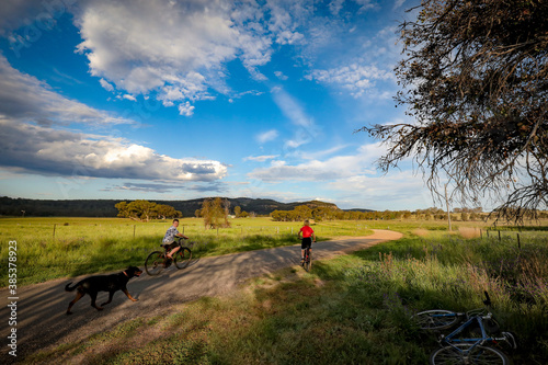 Children riding bikes on remote country lane on a vibrant afternoon