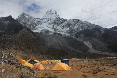 Yellow and orange tents in Ama Dablam Base Camp near Pangboche, Sagarmatha Khumbu Region, Nepal Himalaya photo