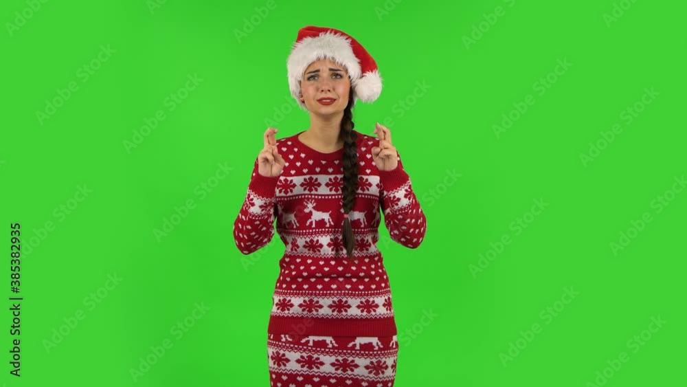 Sweety girl in Santa Claus hat is looking at the camera with excitement, then celebrating her victory. Green screen Sweety girl in Santa Claus hat is looking at the camera with excitement, then celebrating her victory. Green screen