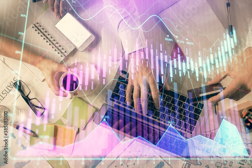 Double exposure of man and woman working together and forex graph hologram drawing. Financial analysis concept. Computer background. Top View. © peshkova