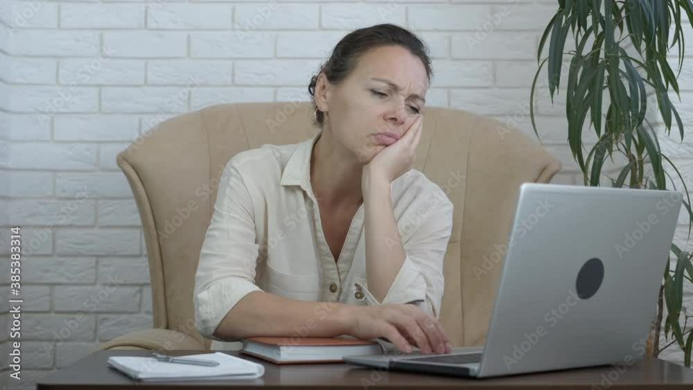 Sleepy freelancer by computer. A fatigue office worker puts her head on the desk at the end of work time in the office. Sleepy freelancer by computer. A fatigue office worker puts her head on the desk at the end of work time in the office.