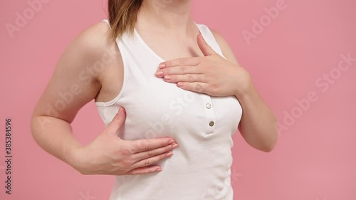 Wallpaper Mural Close up, woman holding silk pink ribbon between her fingers. Breast cancer awareness month pink october. High quality 4k footage Torontodigital.ca