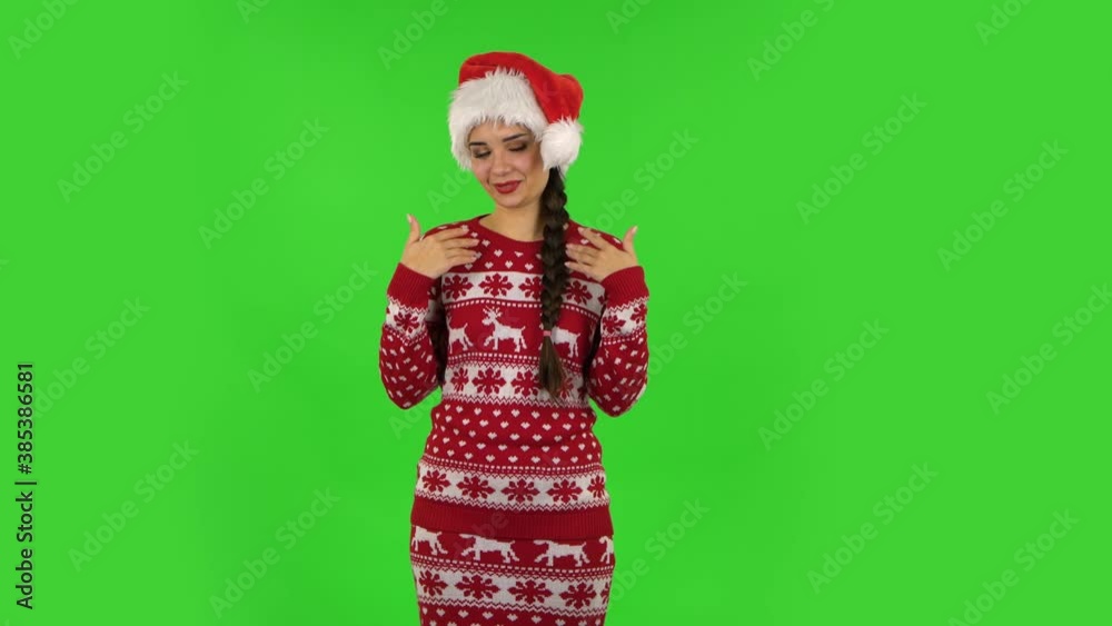 Sweety girl in Santa Claus hat is frightened then sighs with relief and smiles. Green screen Sweety girl in Santa Claus hat is frightened then sighs with relief and smiles. Green screen