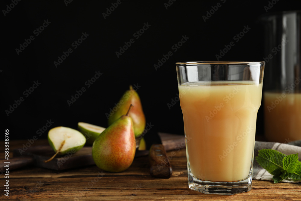 Fresh pear juice in glass on wooden table, closeup. Space for text Fresh pear juice in glass on wooden table, closeup. Space for text
