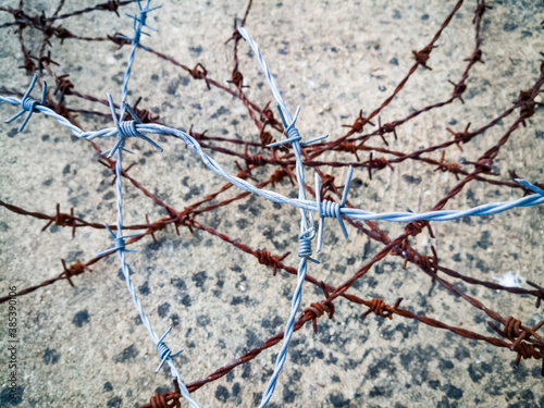 Layers of tangled barbed wire, new and rust 