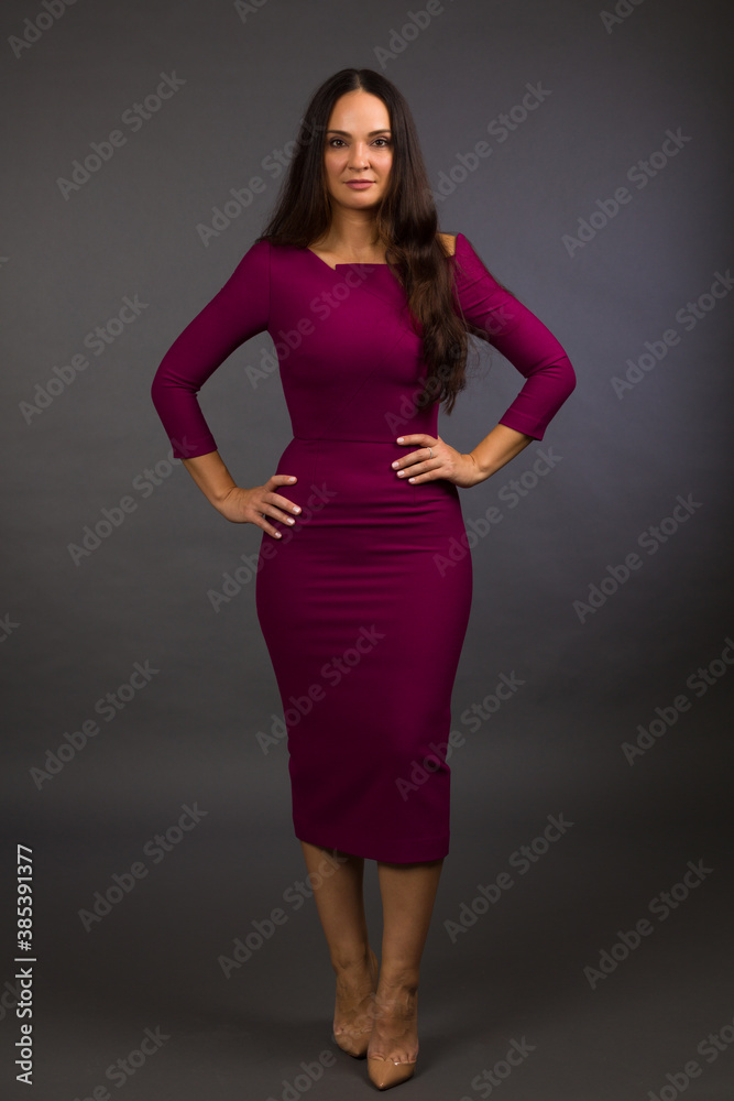 Beautiful young woman studio portrait on a gray background Beautiful young woman studio portrait on a gray background