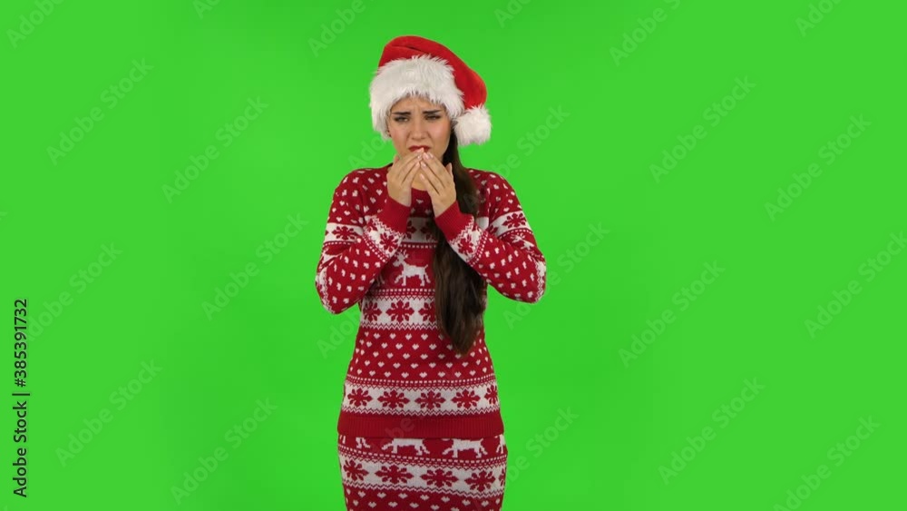 Sweety girl in Santa Claus hat is getting a cold, sore throat and head, cough. Green screen Sweety girl in Santa Claus hat is getting a cold, sore throat and head, cough. Green screen