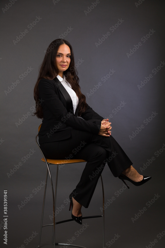 Beautiful young woman studio portrait on a gray background Beautiful young woman studio portrait on a gray background
