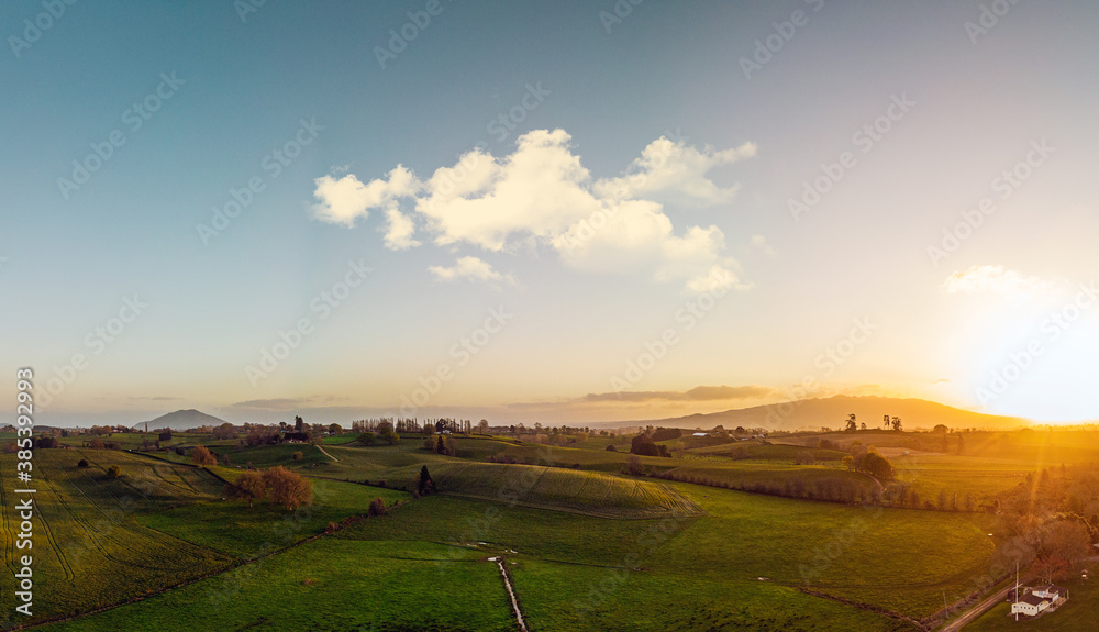 Aerial view of countryside at sunrise. Farmland and rural scenery