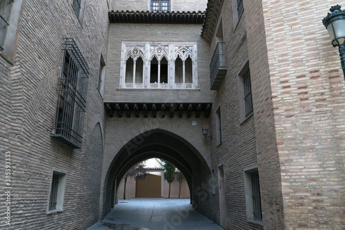 Fototapeta Naklejka Na Ścianę i Meble -  Arch of the Dean through the streets of the old town in Zaragoza, Spain