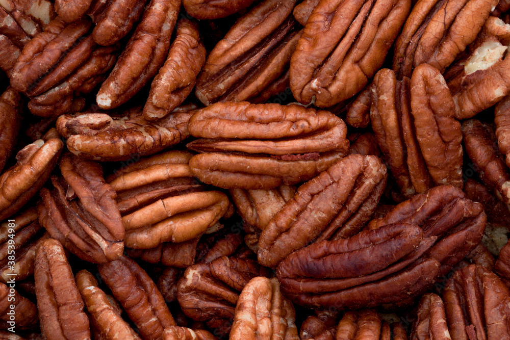 Wellbeing backgrounds, nutritious nut and nutritional value concept with horizontal full frame photograph of group large group of pecan nuts Wellbeing backgrounds, nutritious nut and nutritional value concept with horizontal full frame photograph of group large group of pecan nuts