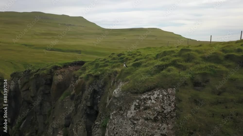 Green cliffs of farroe islands in cloudy weather. Drone aerial view. Green cliffs of farroe islands in cloudy weather. Drone aerial view.