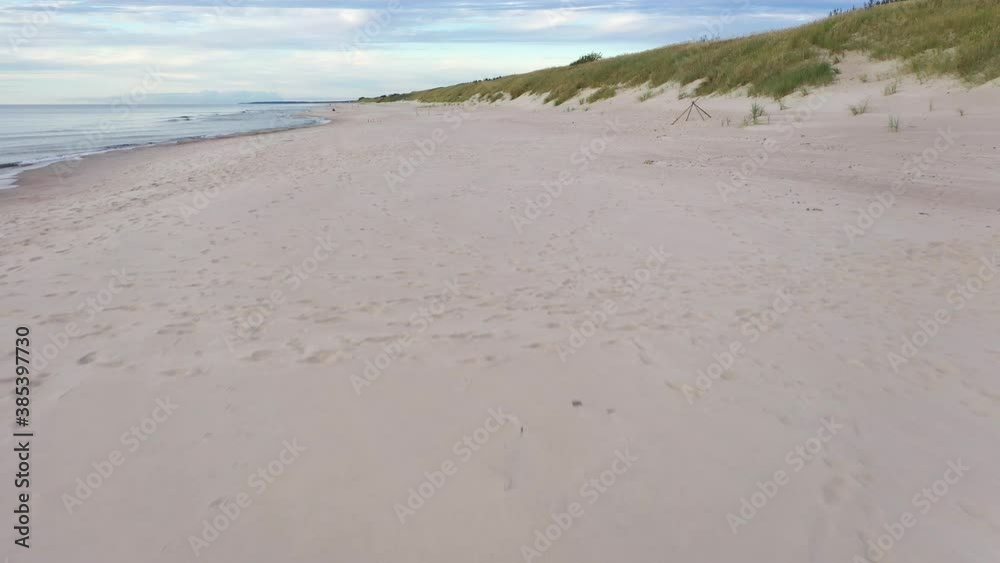 AERIAL: Low and Slow Flying Above Sandy Beach near the Seaside AERIAL: Low and Slow Flying Above Sandy Beach near the Seaside