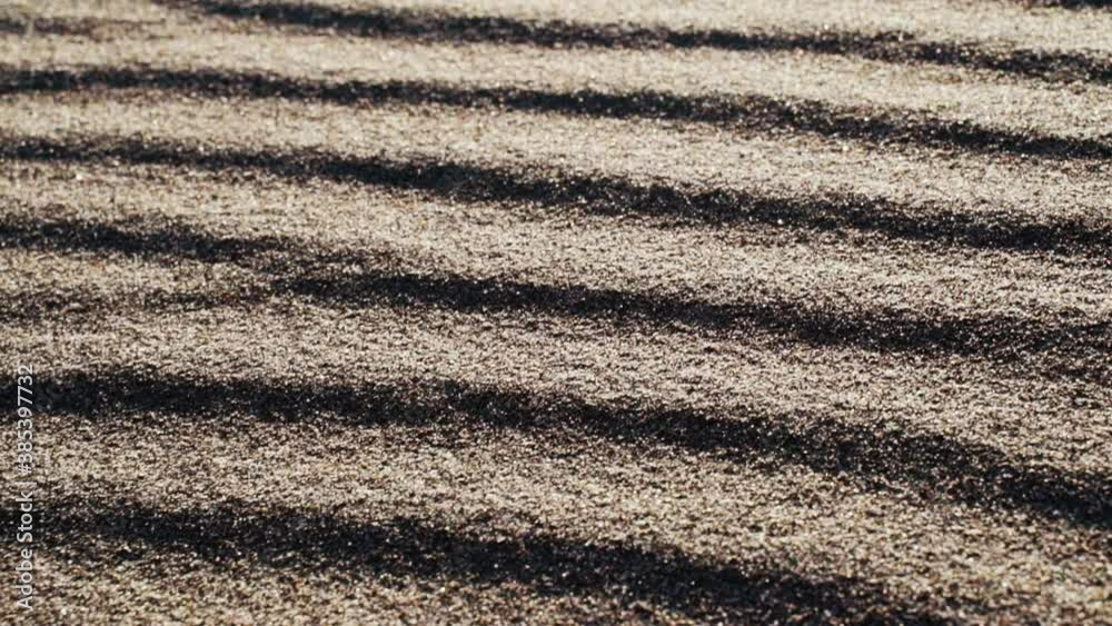 Close up of wind blown patterns on sand, on a tranquil, sunny day, in The great sand dunes national park, in Colorado, USA - tilt down view Close up of wind blown patterns on sand, on a tranquil, sunny day, in The great sand dunes national park, in Colorado, USA - tilt down view