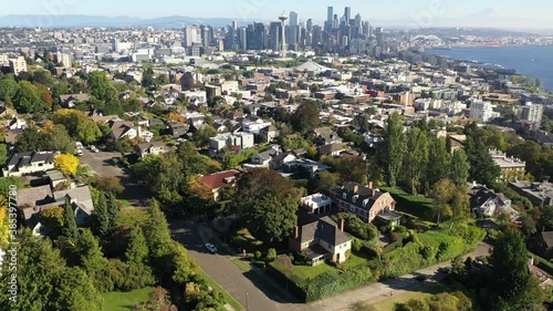 Aerial / drone footage of Queen Anne, an upscale, affluent neighborhood uptown by Puget Sound, with the Seattle skyline in the backdrop in Washington State photo