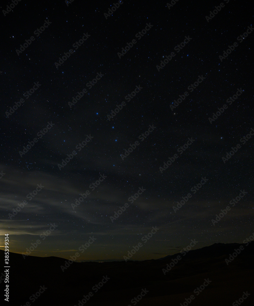 Stars and Clouds Over Sand Dunes