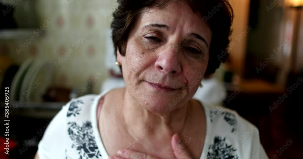 Portrait hopeful older woman putting hand in chest Portrait hopeful older woman putting hand in chest