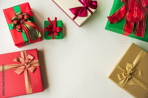 Top view many gift box on the white table. Copy space New year's and Christmas Day concept.