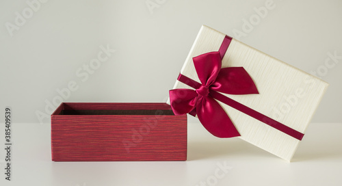 Open Gift box mockup on the white table. Merry christmas and happy new years background for text advertise.