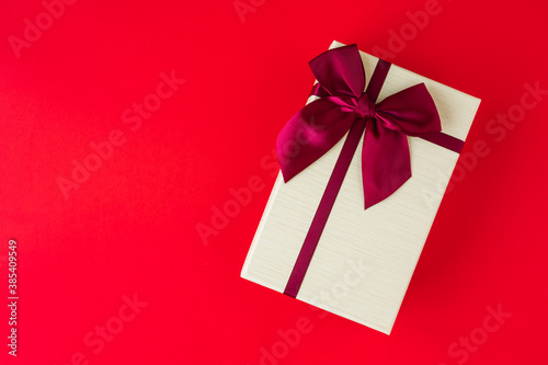 Gift box mockup on the red background with copy space. Merry christmas and happy new years background for text advertise.