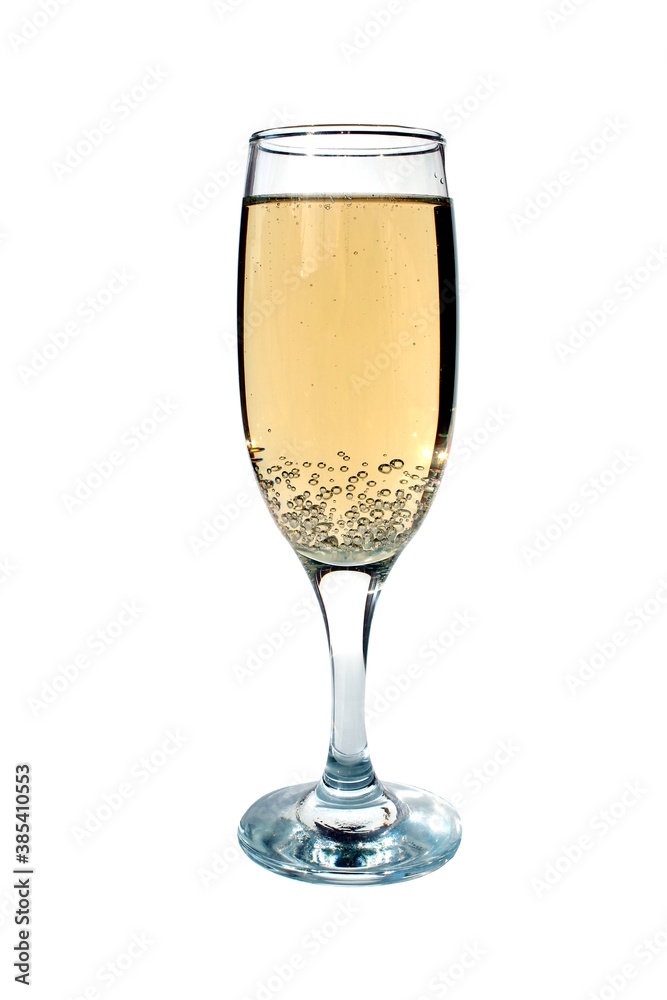 A glass of champagne stands on a white background