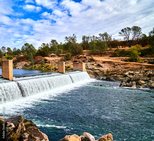 Scenic view of Lake Oroville California dam in fall with blue sky and white clouds 