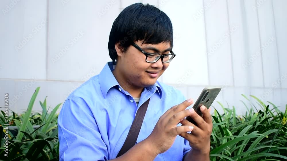 Asian man holding a modern smartphone in the office Young businessmen use mobile apps that are helpful for management organization ideas. Global network information display Line bridging technology
Asian man holding a modern smartphone in the office Young businessmen use mobile apps that are helpful for management organization ideas. Global network information display Line bridging technology