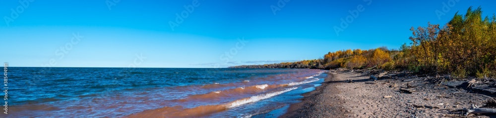 Panoramic view of lake superior beach with rocks and driftwood