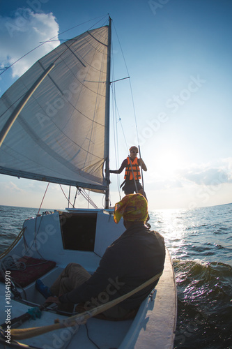 A man and a woman are traveling on a sailing yacht.