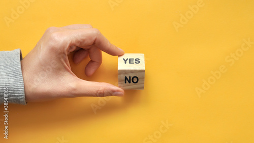 Words: Yes and No on wooden cubes. Choosing between Yes and No in life