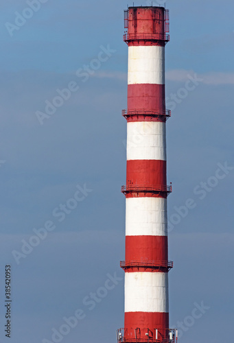 The chimney of a gas boiler on the background of a blue sky close-up