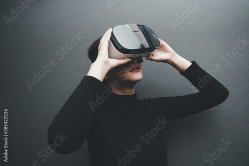 Smiling positive woman wearing virtual reality goggles headset, vr box. Connection, technology, new generation, progress concept. Female, augmented. blurred.