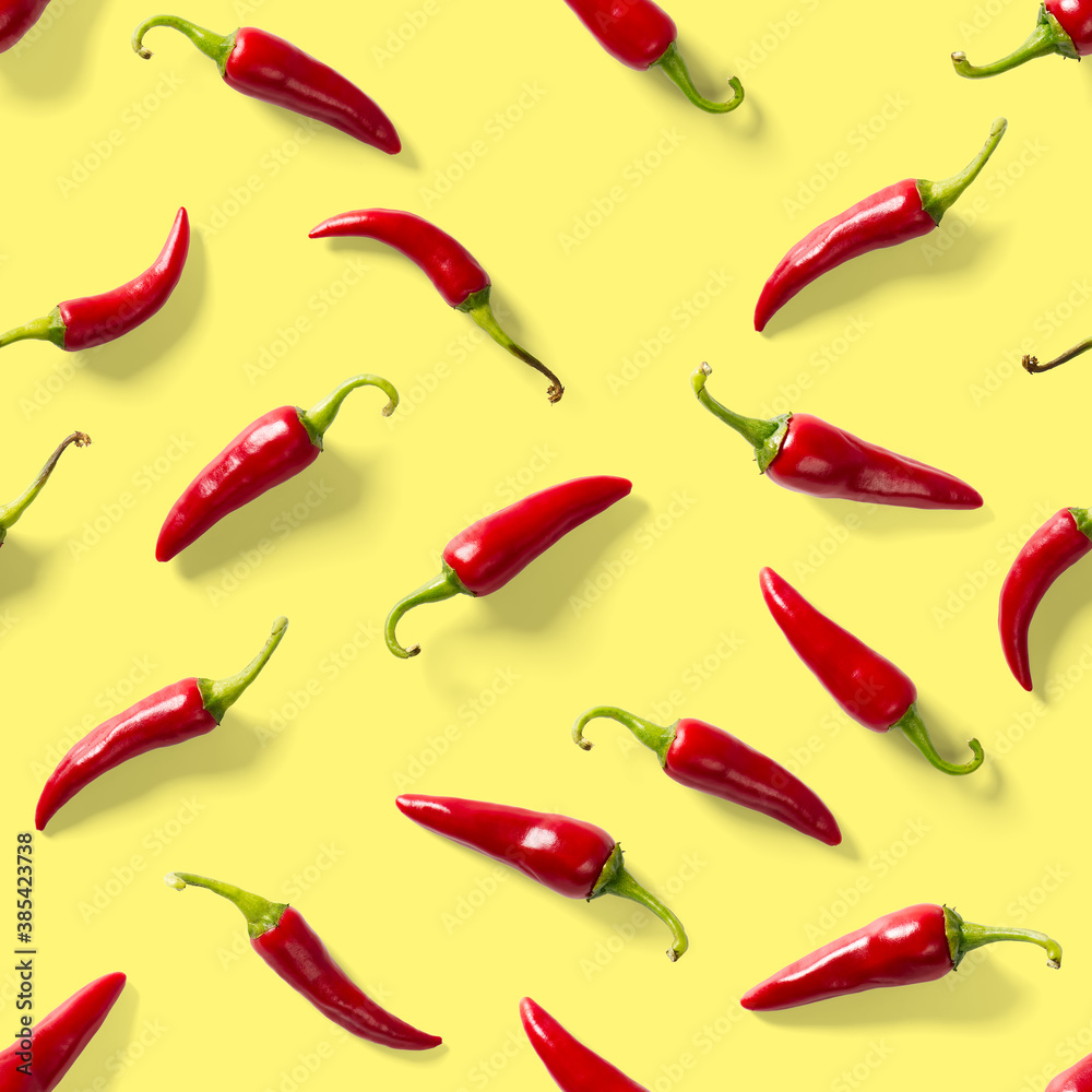 Seamless pattern made of red chili or chilli on yellow background. Minimal food pattern. Red hot chilli seamless peppers pattern. Food background. Seamless pattern made of red chili or chilli on yellow background. Minimal food pattern. Red hot chilli seamless peppers pattern. Food background.