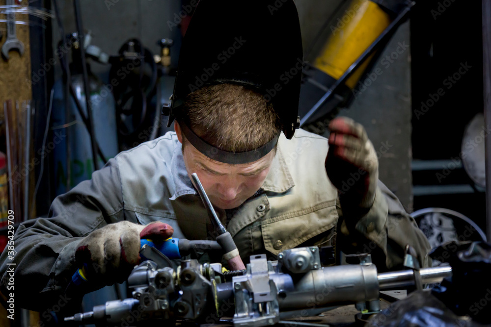 Close-up portrait of a welder in the workplace Close-up portrait of a welder in the workplace