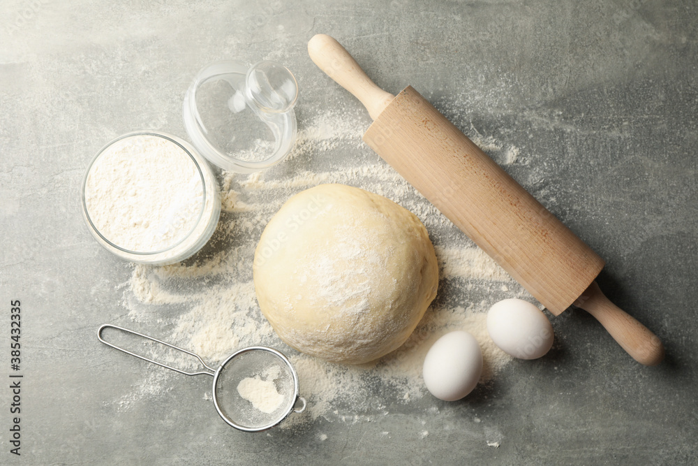 Concept for baking with dough on gray background Concept for baking with dough on gray background