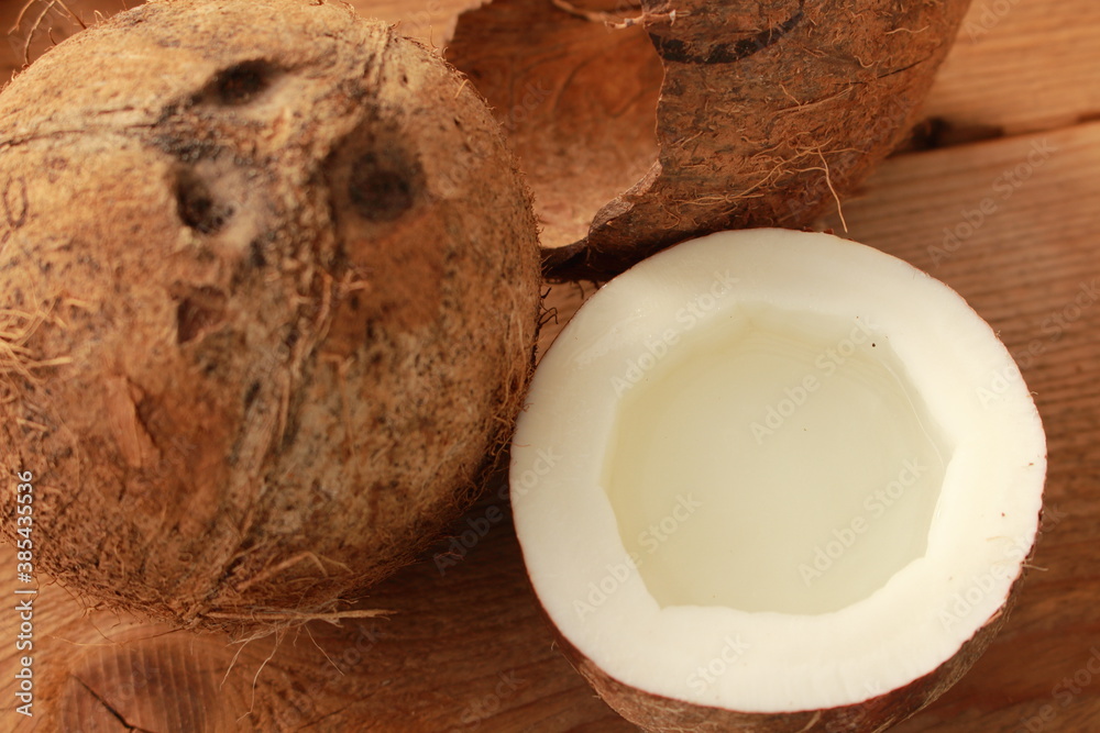 a sliced coconut with coconut milk in a glass a sliced coconut with coconut milk in a glass