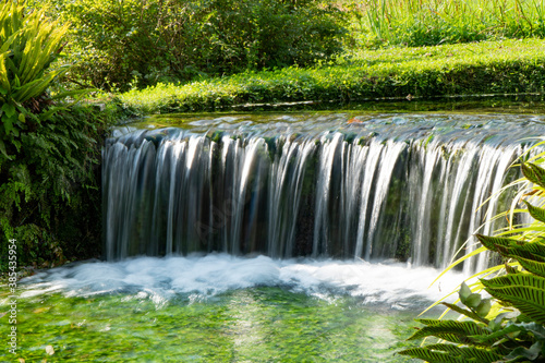 Small artificial waterfall in the Ninfa Garden in Italy