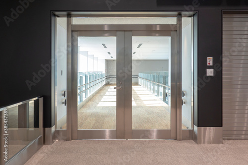 Transparent door on corridor of modern building