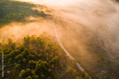 Misty sunrise in the mountains with a beautiful sky. Aerial view