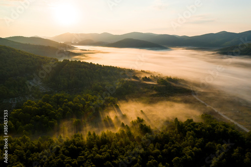 Misty sunrise in the mountains with a beautiful sky. Aerial view