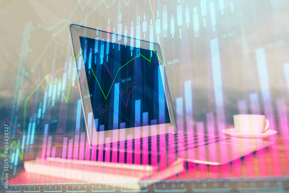 Financial market graph hologram and personal computer on background. Multi exposure. Concept of forex. Financial market graph hologram and personal computer on background. Multi exposure. Concept of forex.