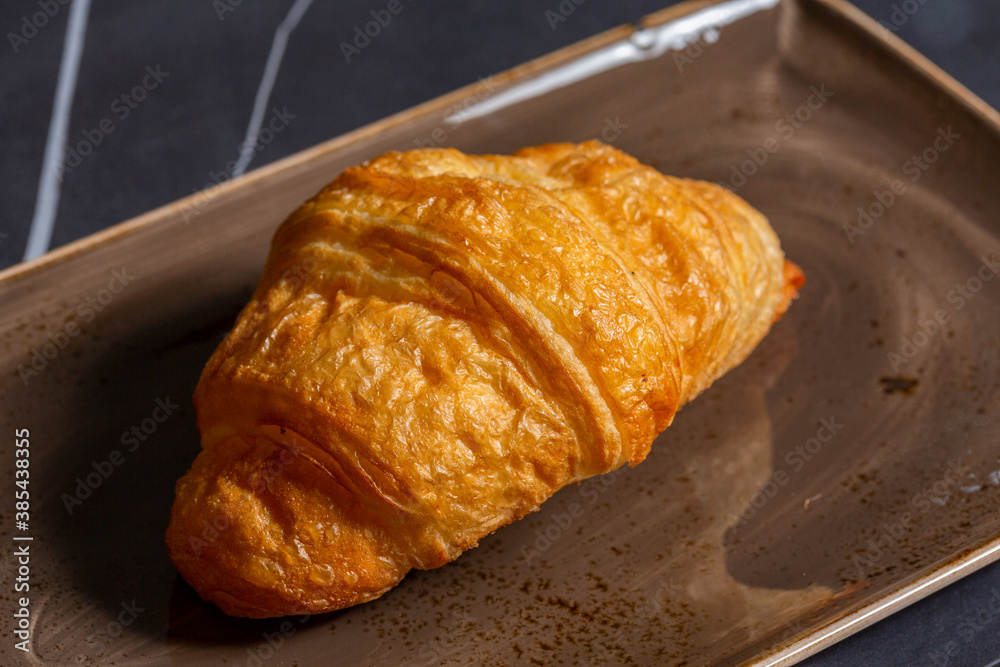 Croissant served on a plate Croissant served on a plate