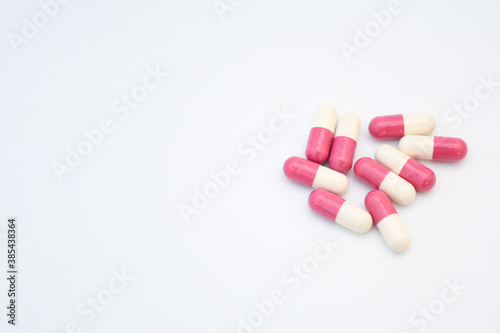 Medicine pink pills in tablet and capsul on white background with space for text. Medicine for heal or vitamin for healthy  concept. Selective foucus. photo